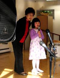 a girl singing with her grandma